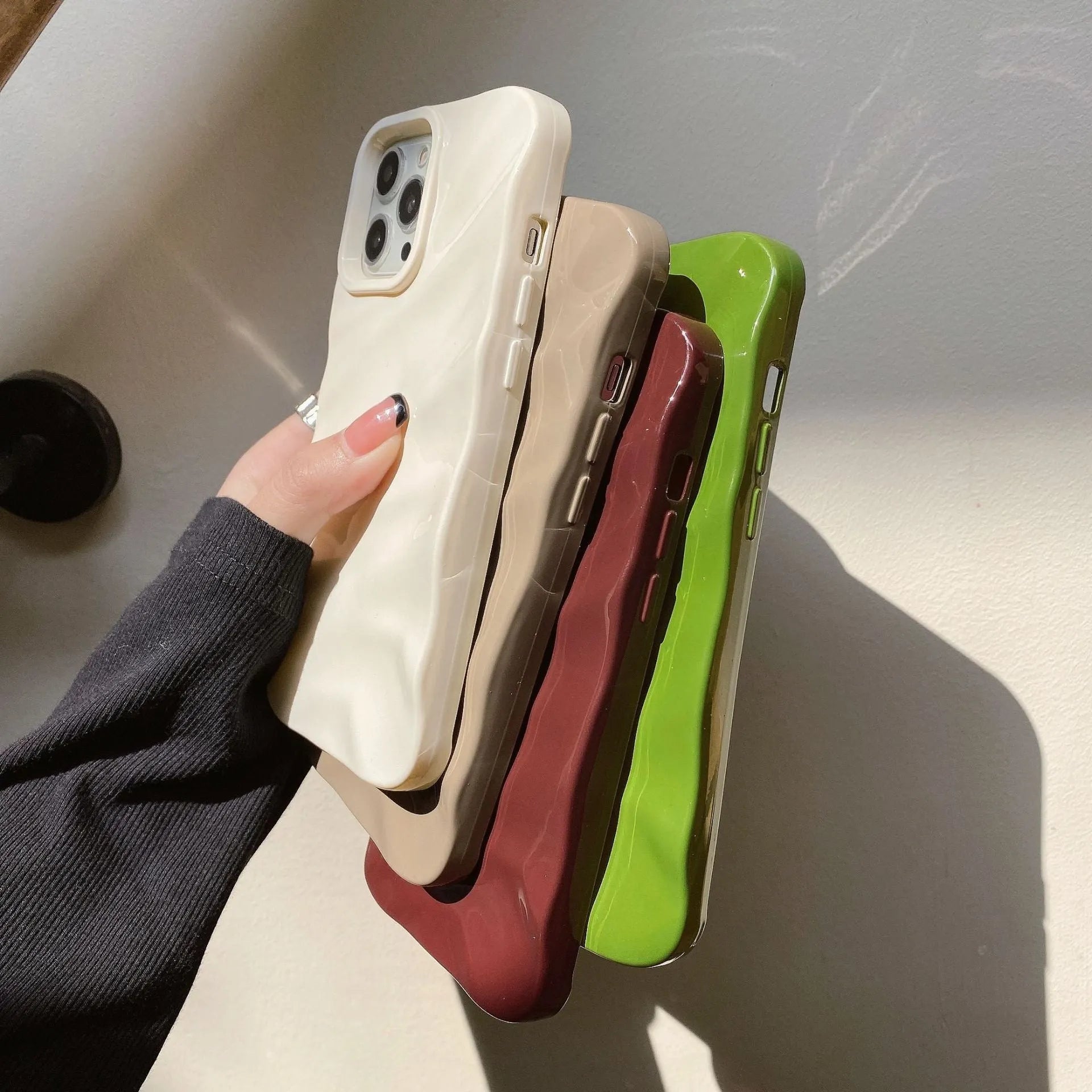 Wave patterned soft TPU phone case for Apple iPhone in burgundy colour showing anti-fall design.