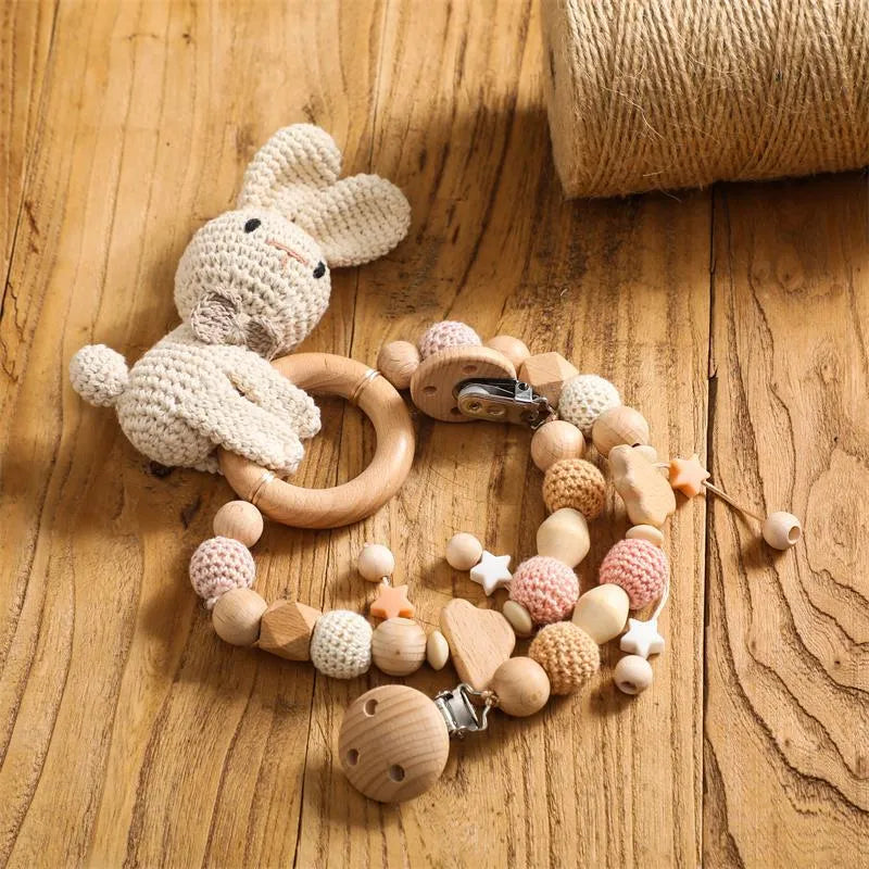 Baby crib hanging bunny music toy with metal construction in cart chain rabbit colour, showing biteable pendant for infant soothing and development.