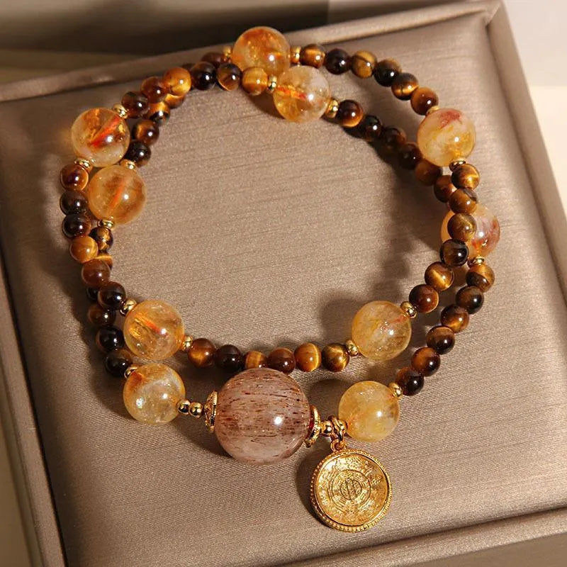 Double circle natural citrine tiger-eye bracelet with yellow tower crystal on white background
