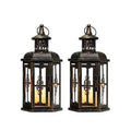 Black retro metal candle holder with glass insert on a wooden surface