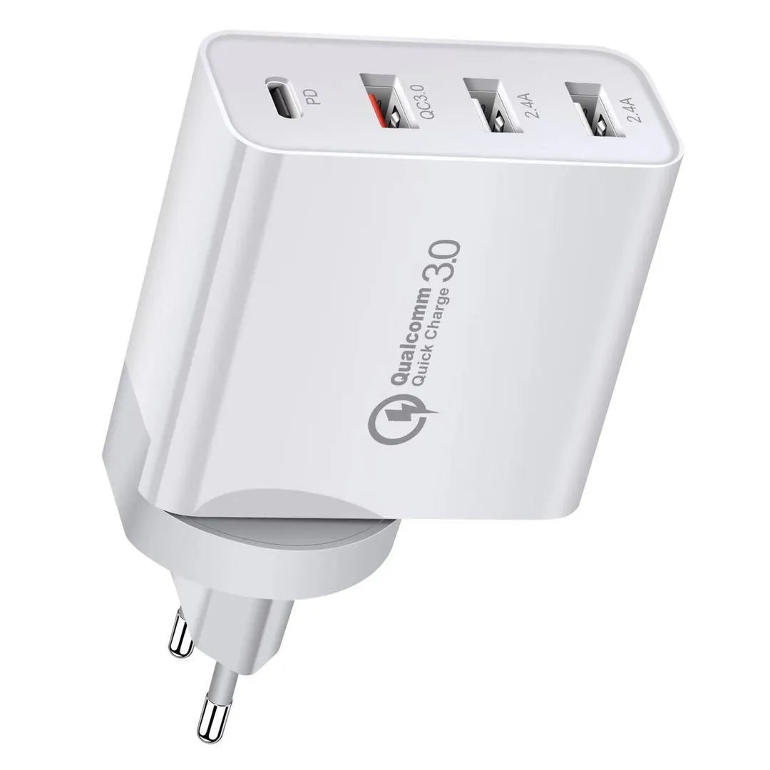 White 4-port USB fast charger with UK plug on a wooden surface.
