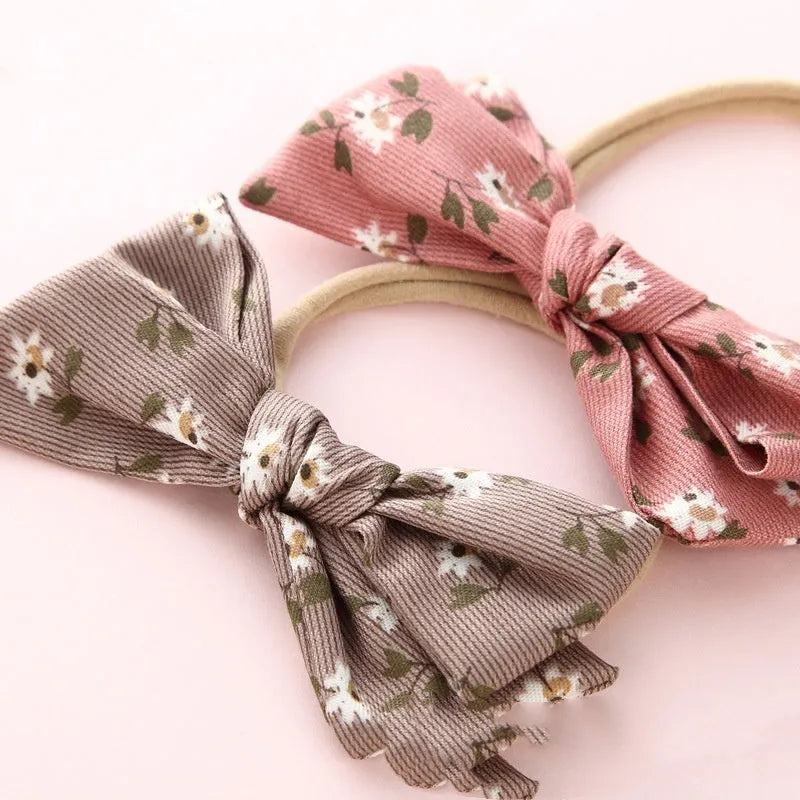 Children's cloth hair band with knotted bow design in one of six colour options featuring snow white princess printing