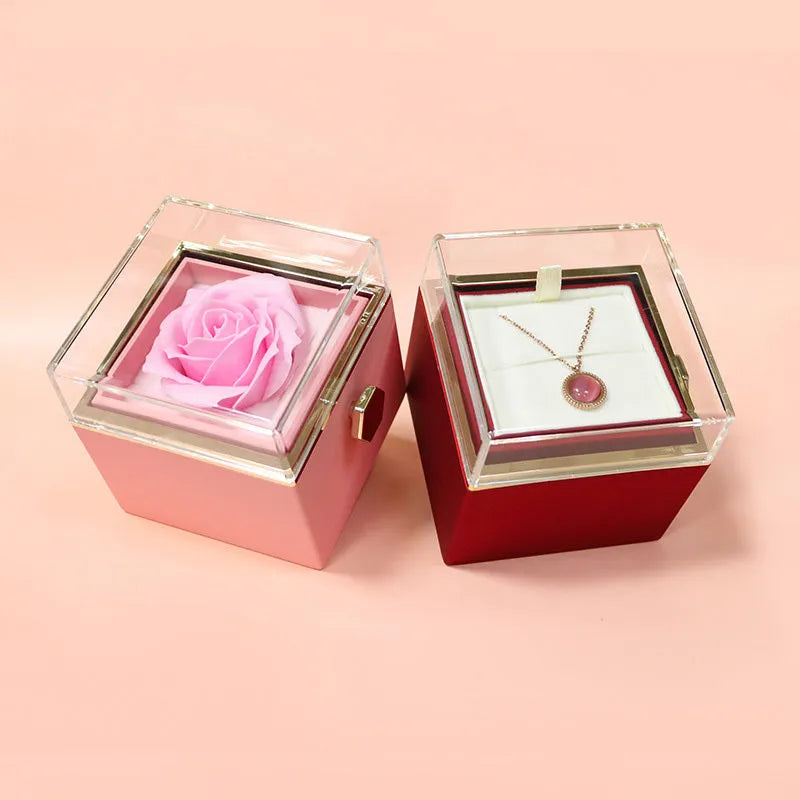 Rotating jewellery box with preserved red rose under acrylic cover and drawer open showing storage