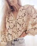Loose fit black lace cardigan with V-neck, hollow long sleeves, and raised three-dimensional floral lace decoration.
