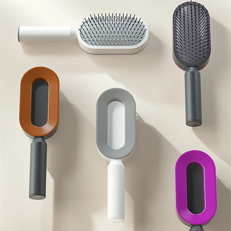 Self-cleaning hair brush with air cushion bristles in black gold, white, or purple colours
