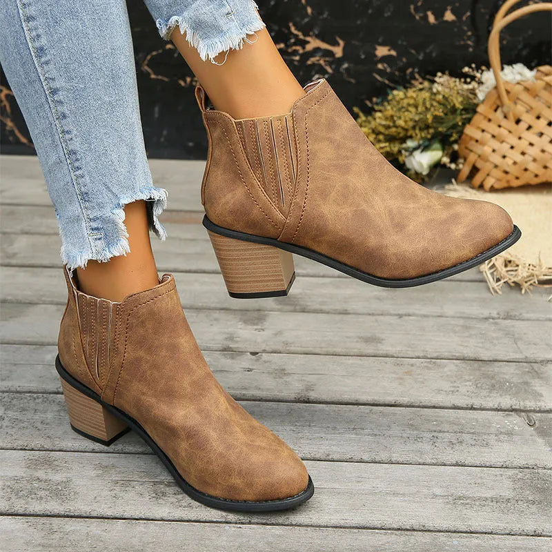 Women's black ankle boots with pointed toe and thick square heel, slip-on design