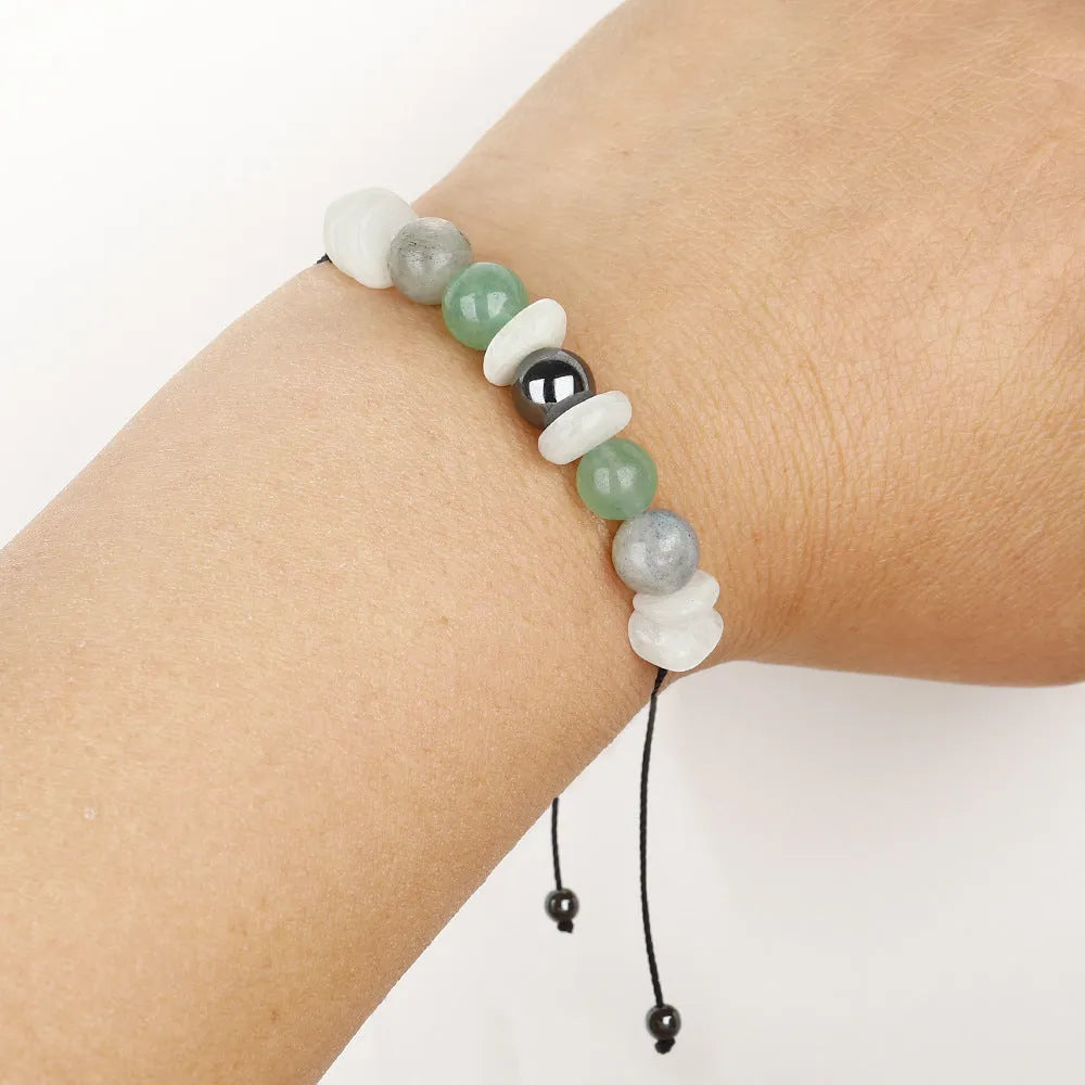 A handcrafted women's bracelet with geometric stone beads in colour 3906 on a wrist.
