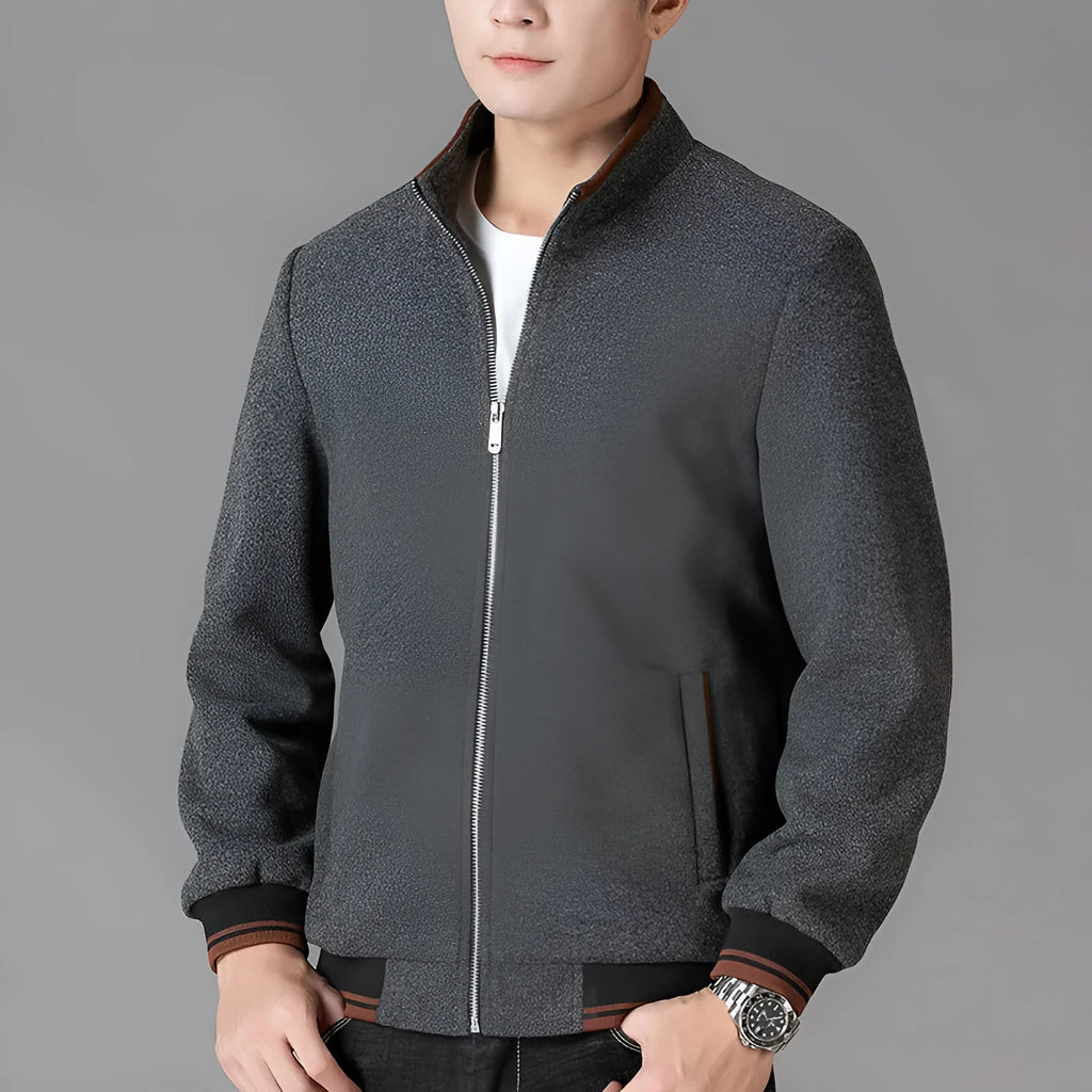 Men's grey polyester fleece jacket with zip front, long sleeves, and a chest pocket, shown on a hanger.