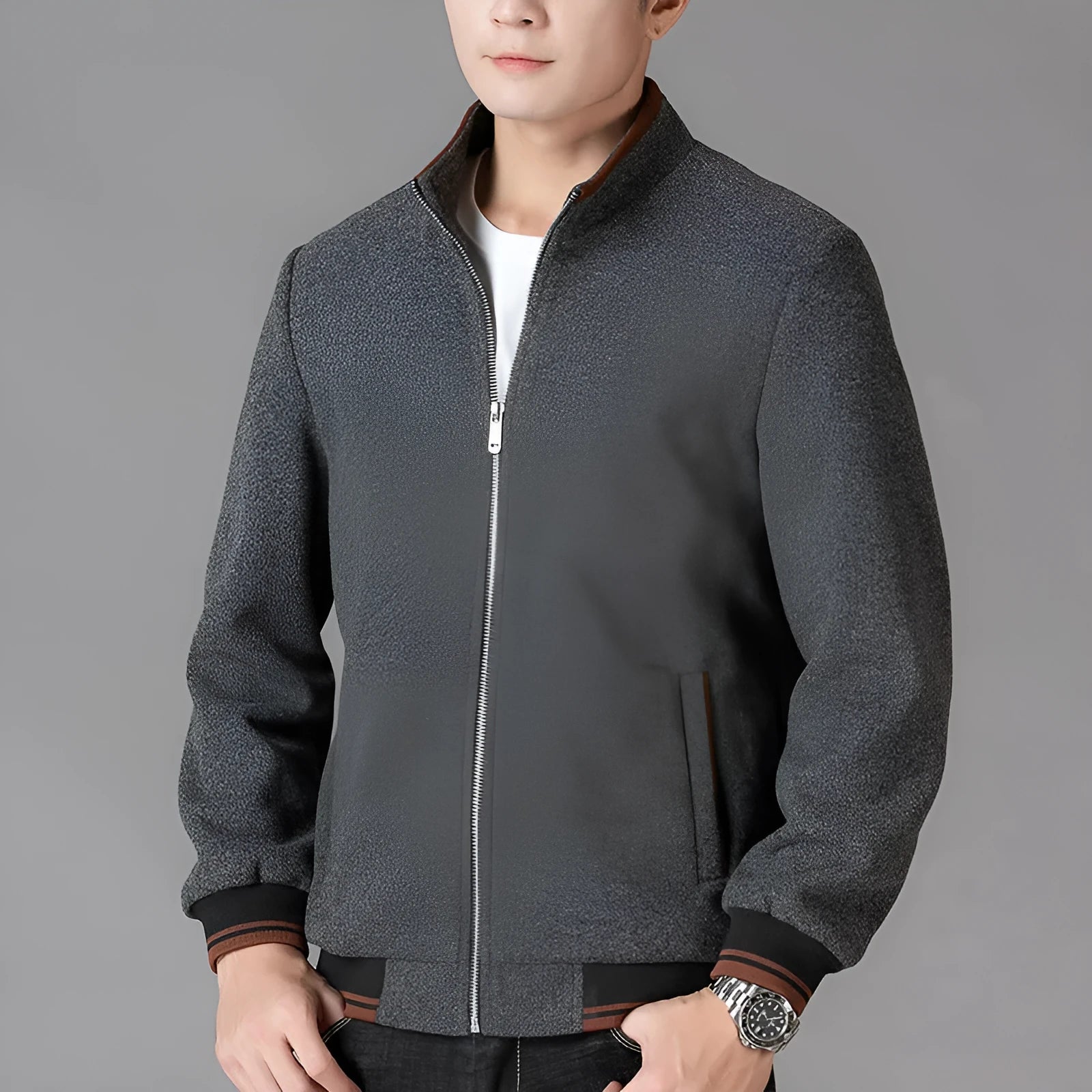 Men's grey polyester fleece jacket with zip front, long sleeves, and a chest pocket, shown on a hanger.