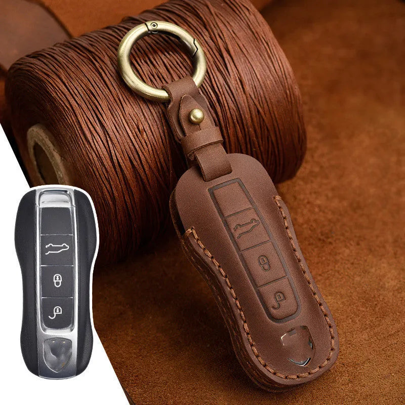 Blue leather Porsche key case with metal bag buckle showing 3 keys inserted