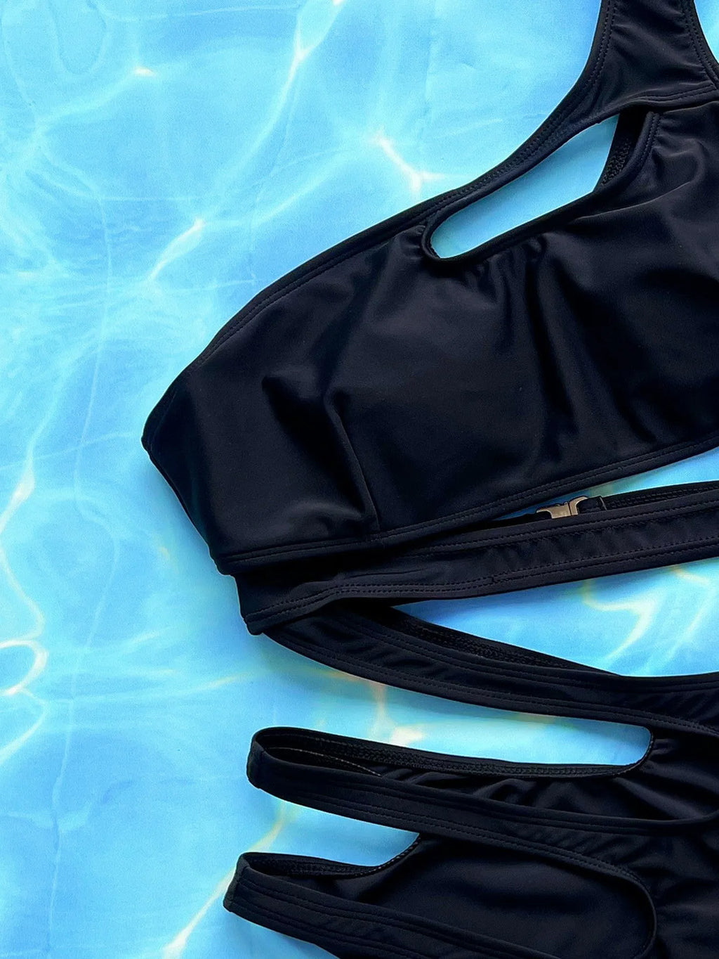 Black women's one-piece swimsuit with hollow-out strap design.