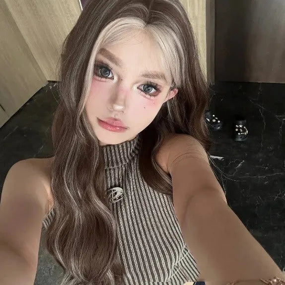 A long curly synthetic wig in a lace grey gold colour on a mannequin head.