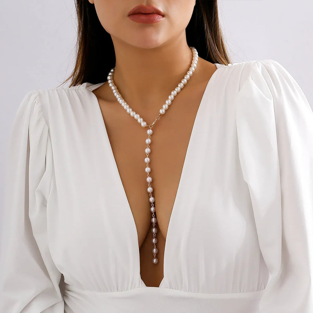 Round bead chain imitation pearl pendant necklace in gold tone with metal construction