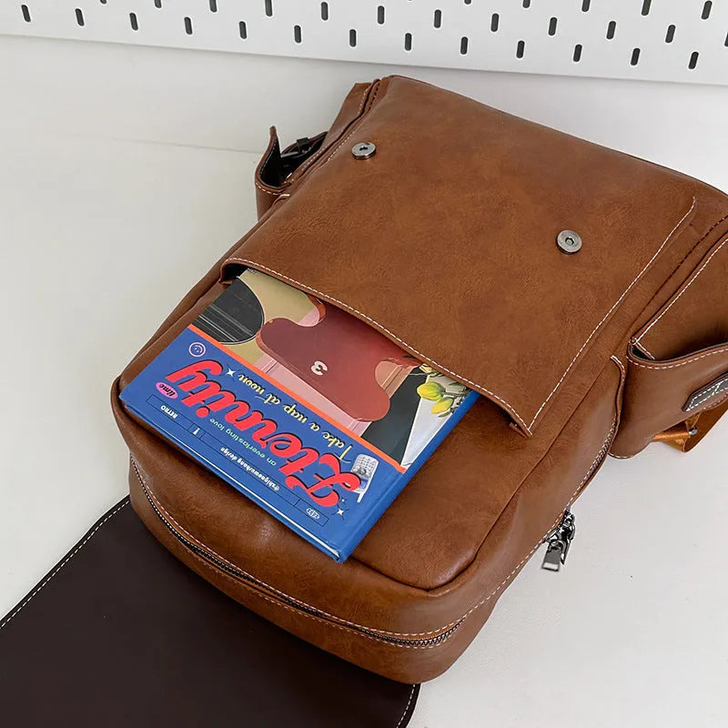 Retro leather travel backpack in black, dark brown, or brown with curved shoulder straps and 20-35L capacity