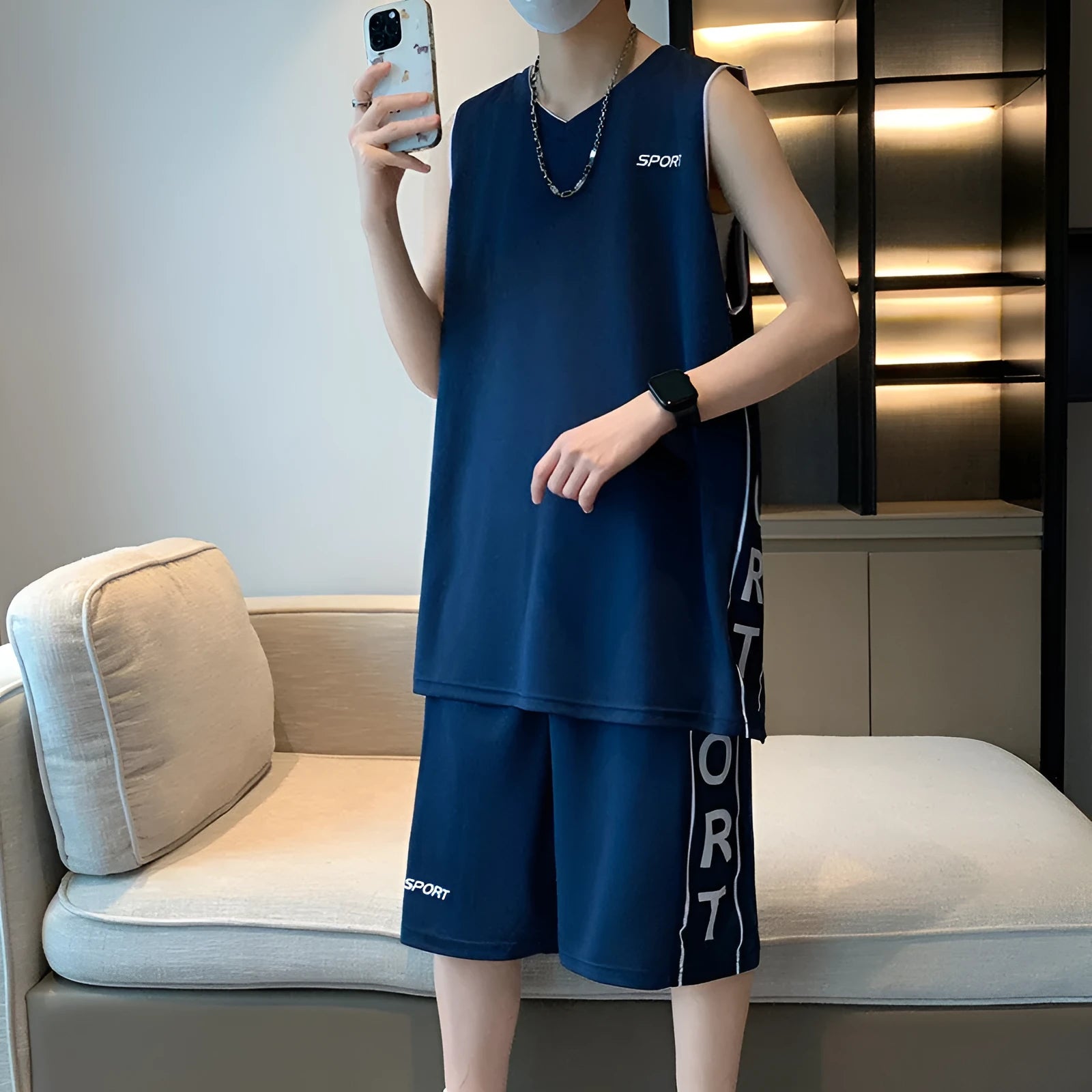 Men's grey polyester sleeveless basketball vest and matching shorts sports set laid flat