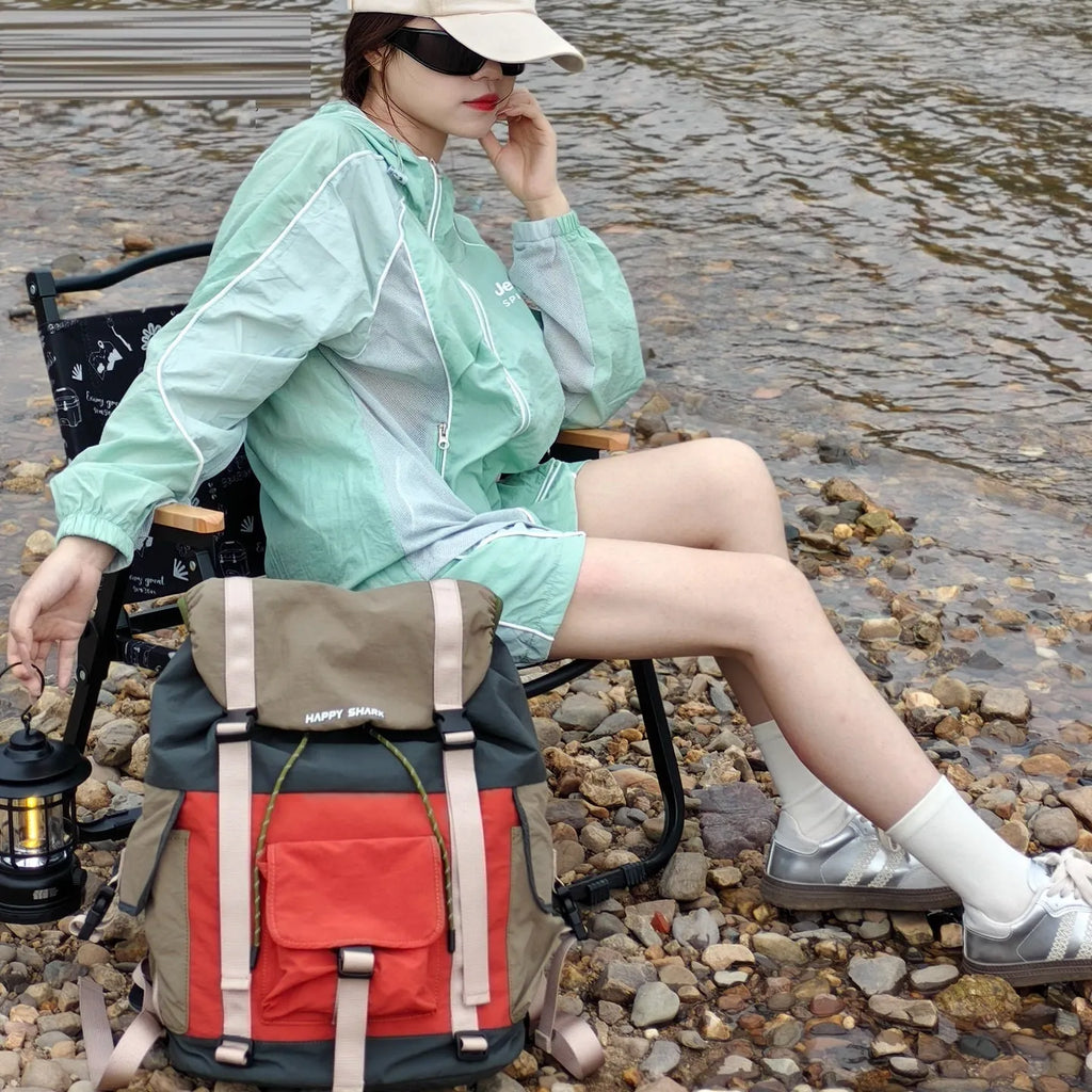 Orange and green contrast colour outdoor backpack with multiple compartments and air pillow belt system