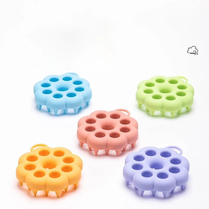 Silicone pet grooming brush in multiple colours for dogs and cats, showing flexible bristles.