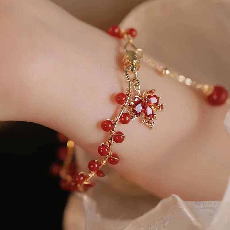 Red Chinese style magnetic bracelet with maple leaf and ginkgo leaf designs on alloy band