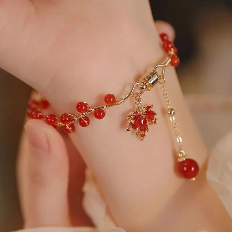 Red Chinese style magnetic bracelet with maple leaf and ginkgo leaf designs on alloy band