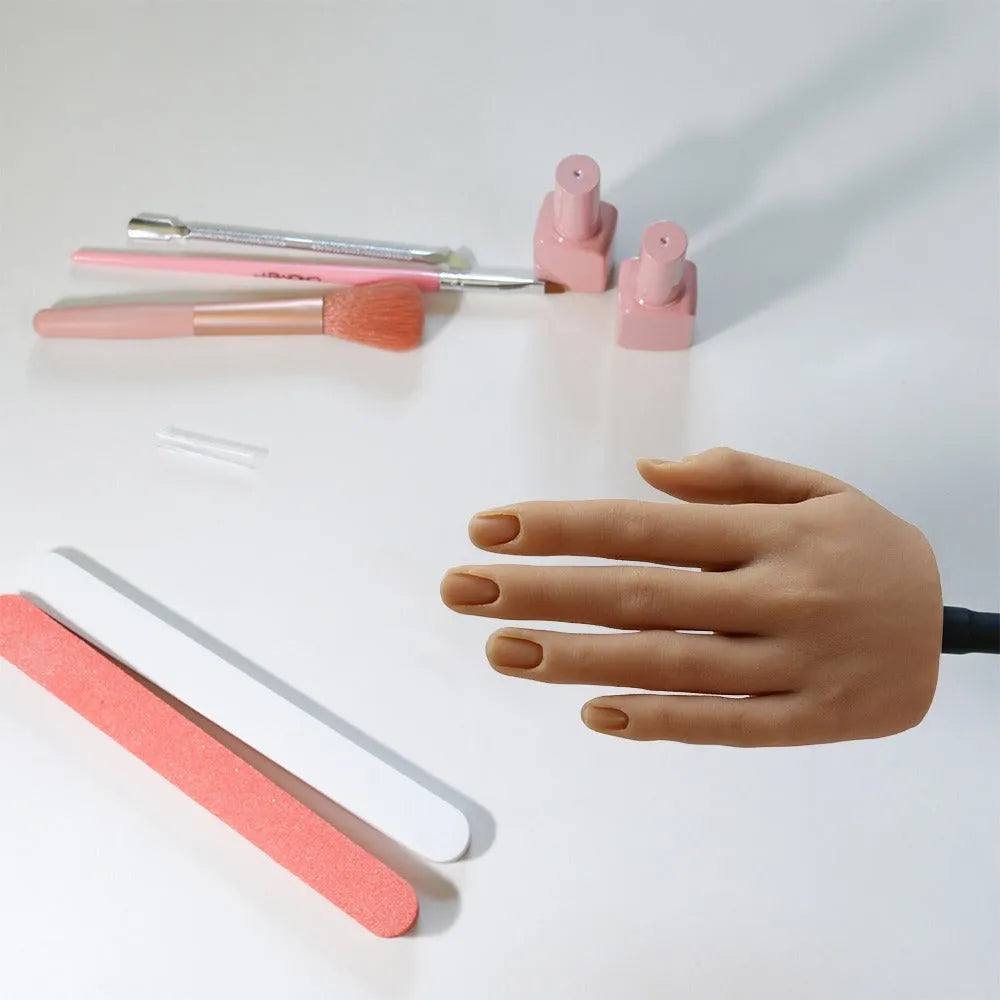 Silicone nail art practice hand model for manicure training on a table.