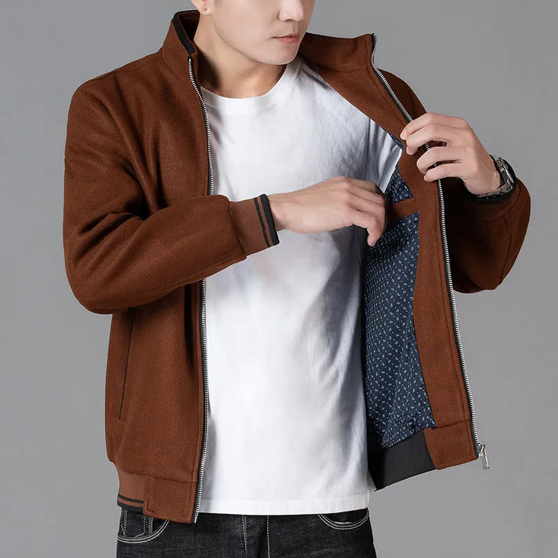 Men's grey polyester fleece jacket with zip front, long sleeves, and a chest pocket, shown on a hanger.