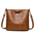 Women's PU leather crossbody bucket bag with wide strap, outer slit pocket, and internal phone and file pockets.