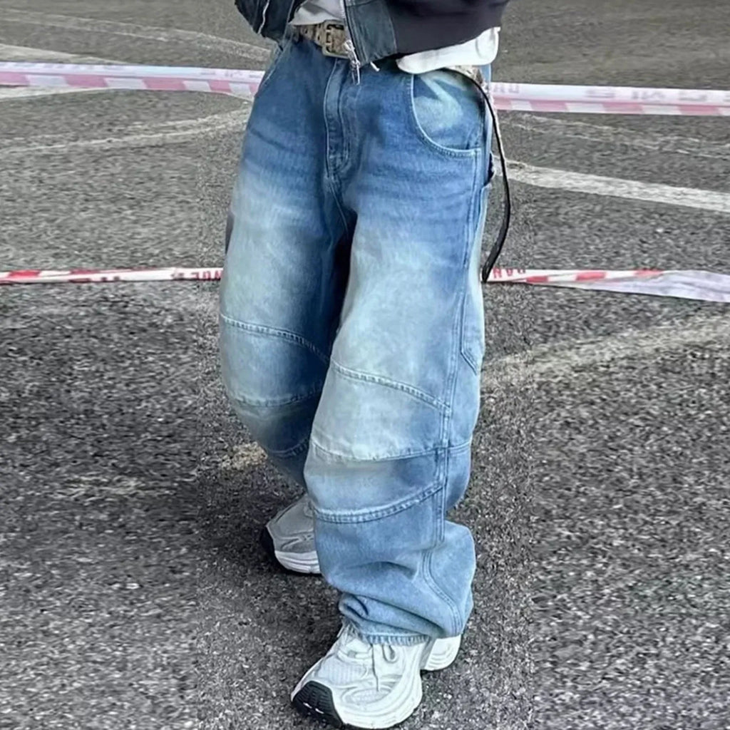 Baggy blue jeans with front pleats and a straight leg, shown in a washed denim finish.