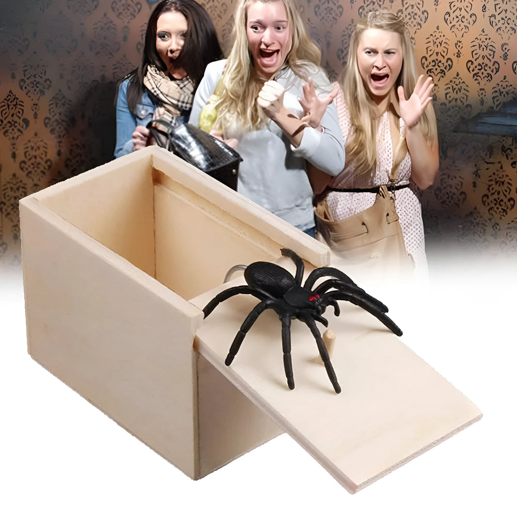 Wooden prank box with lid open showing a lifelike jumping spider inside on a white background.