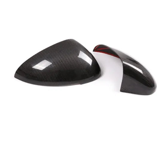 True carbon fibre exterior rearview mirror covers for a black Porsche Macan.