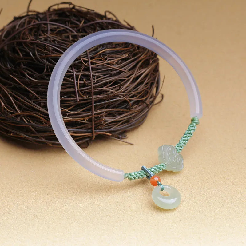 Handmade natural white agate bracelet with jade green Hetian jade charm on an adjustable cord.