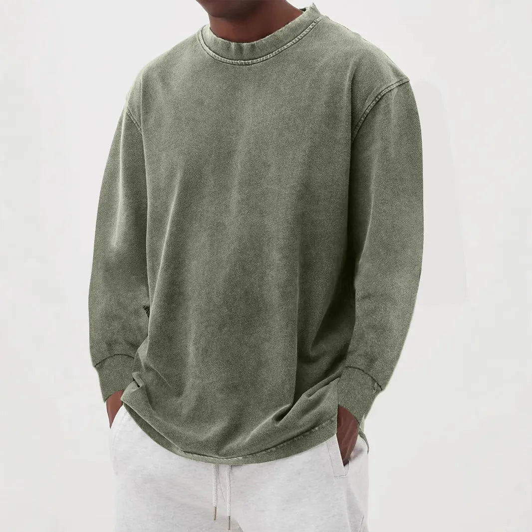 Man wearing a slim fit long sleeve t-shirt in a solid colour, with options in sky blue, green, gray, black, and camel.