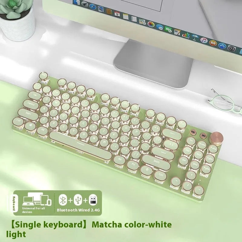 Matcha green 87-key mechanical gaming keyboard with aluminium frame and white backlighting on a desk.
