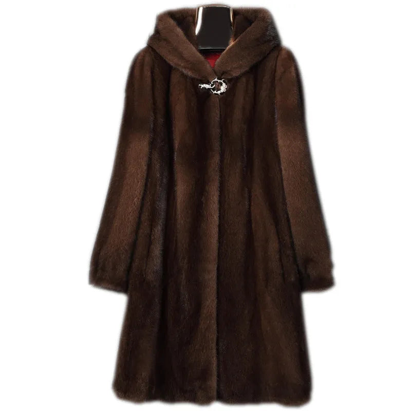 A woman's long black faux fur coat with a hood, shown in a street fashion style.