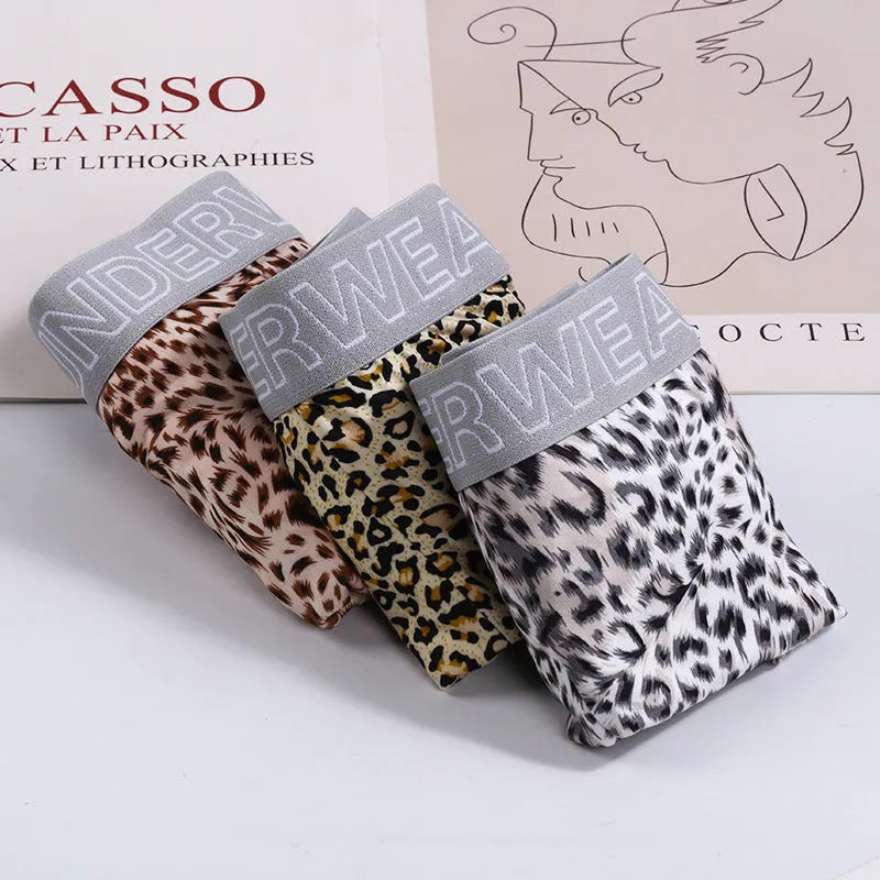 Men's loose fit leopard print boxer shorts showing mid-waist design and polyester knit fabric texture