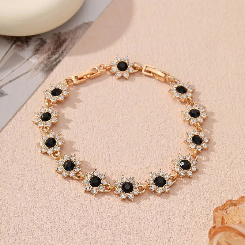 Luxury style bracelet with coloured gems and floral design on zinc alloy with electroplated finish