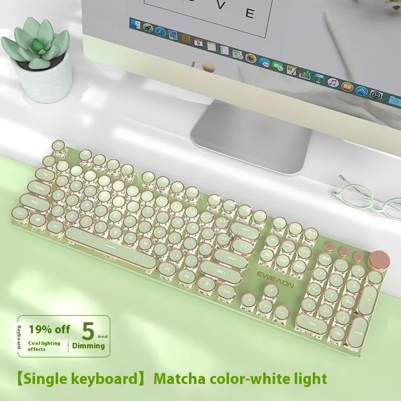 Matcha green 87-key mechanical gaming keyboard with aluminium frame and white backlighting on a desk.