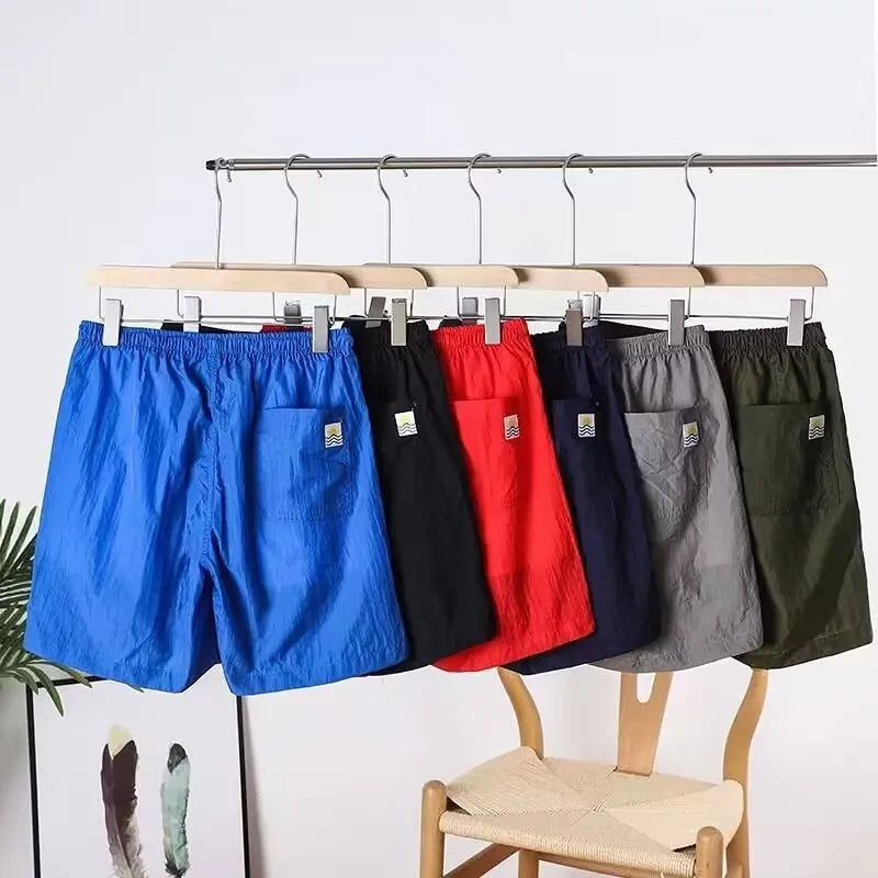 Men's straight-leg quick-dry sports shorts in grey on a hanger