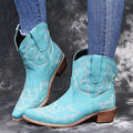 Blue embroidered women's cowgirl boots with a low wedge heel and pointed toe.