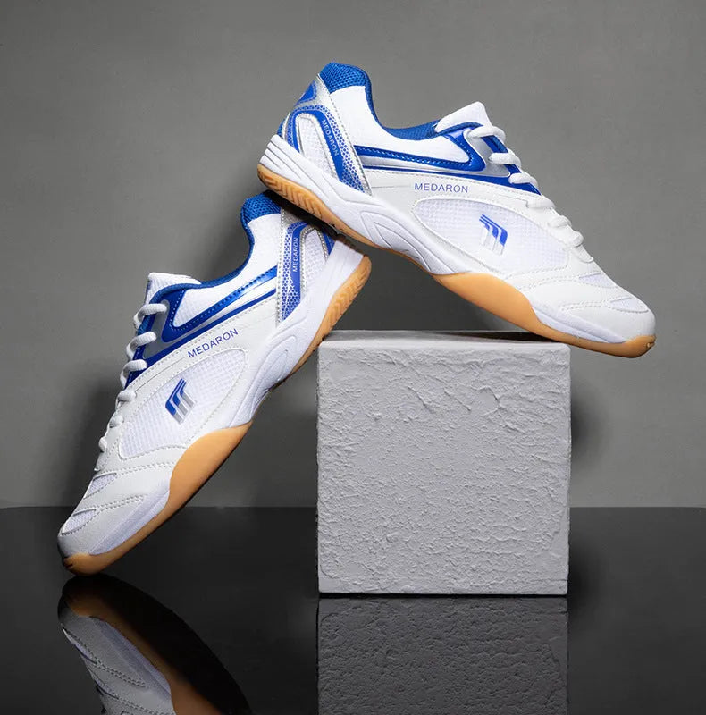 White and blue table tennis sneakers with lace-up front, round toe, and rubber sole.