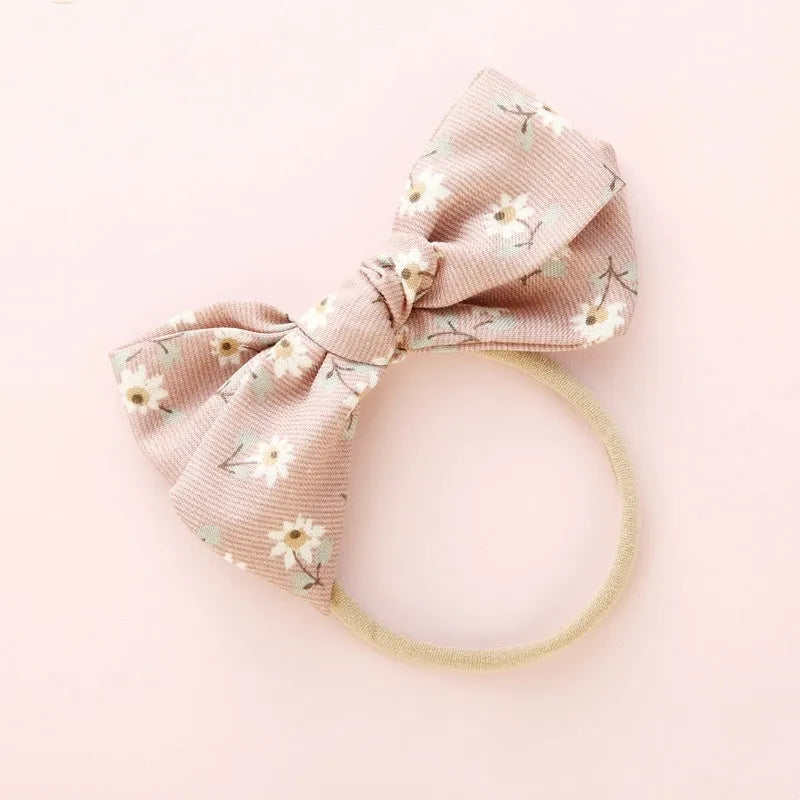 Children's cloth hair band with knotted bow design in one of six colour options featuring snow white princess printing