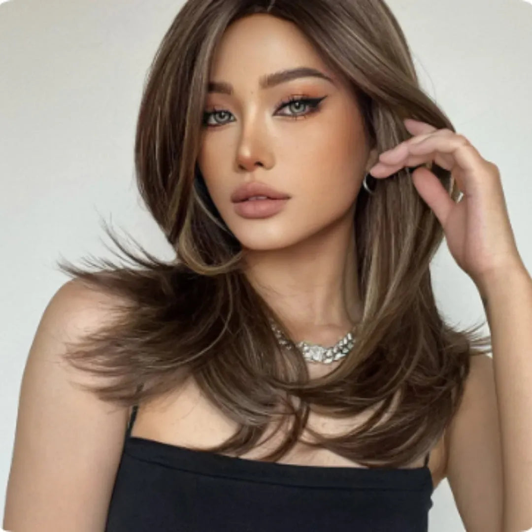 Mid-length curly synthetic wig with long bangs in a platinum gradient colour