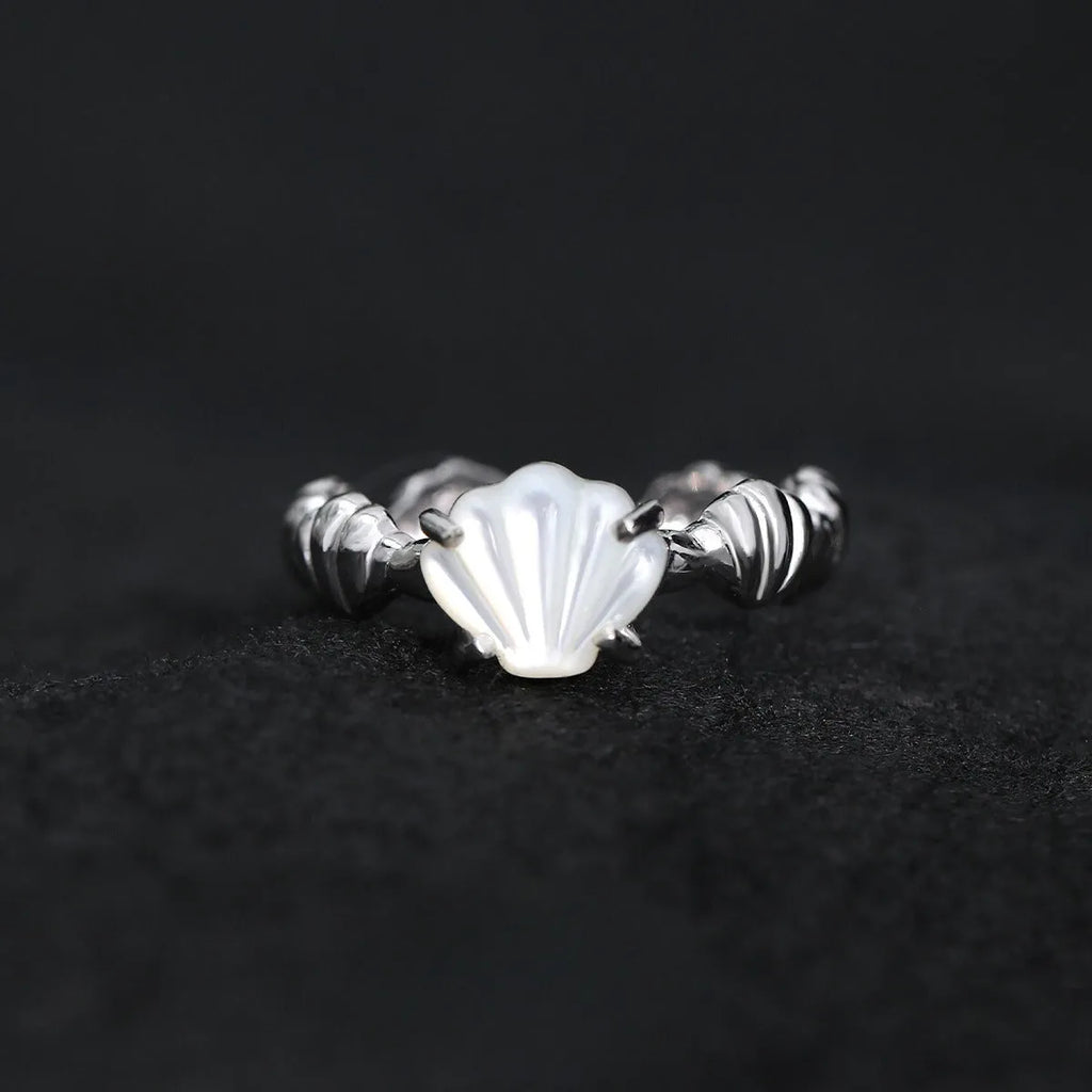 Adjustable silver ring with a shell design and tiger eye stone in white gold or gold finish.