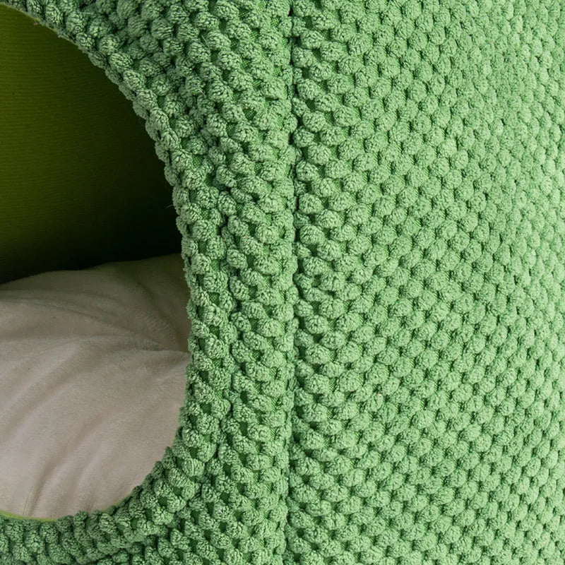 Green enclosed plush cat bed or pet cave for kittens and small dogs.