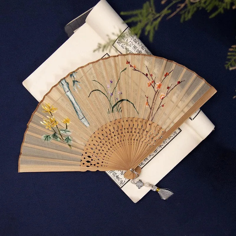 7-inch bamboo folding silk embroidered fan showing traditional Chinese embroidery designs