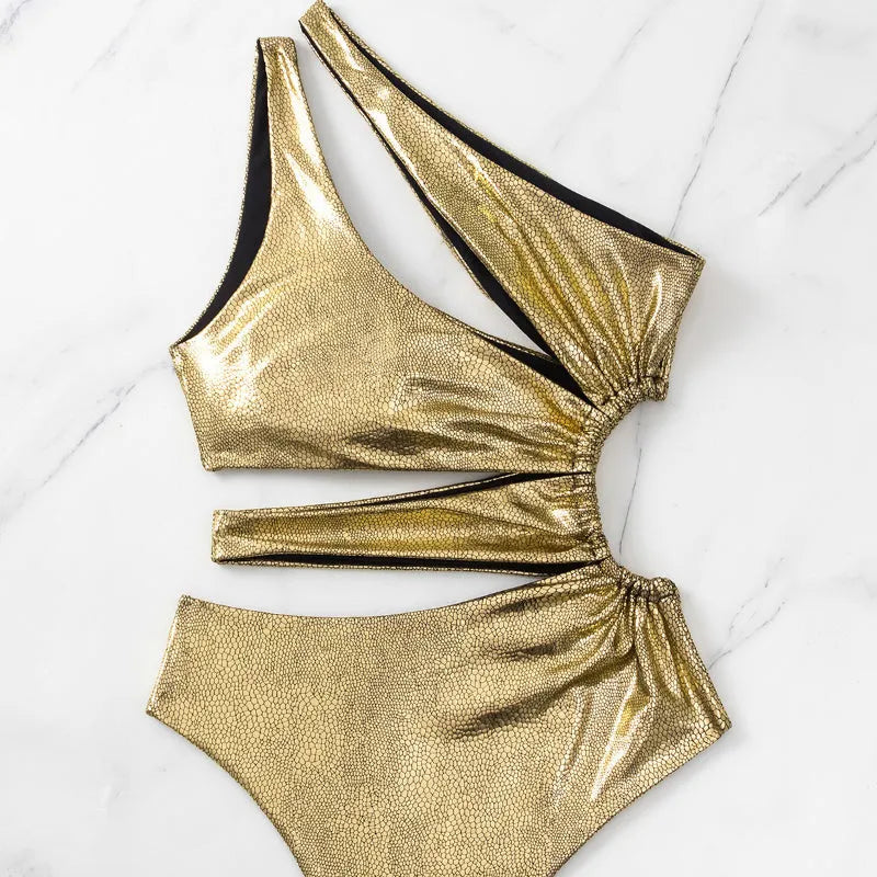 Women's solid gold backless one-piece swimsuit on a white background.