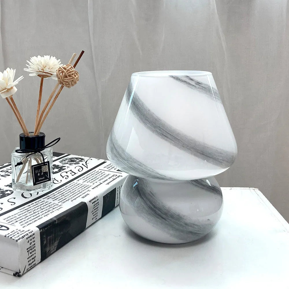 Handmade glass mushroom table lamp in Earth colour on wooden bedside table, 15cm by 19cm