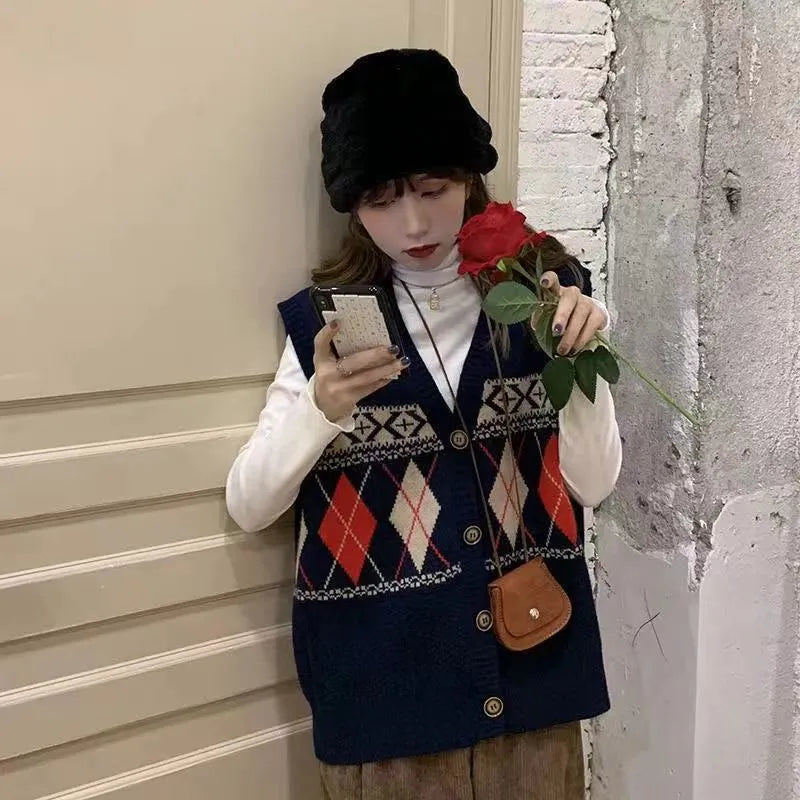 Khaki diamond plaid sleeveless loose cardigan top on a hanger.