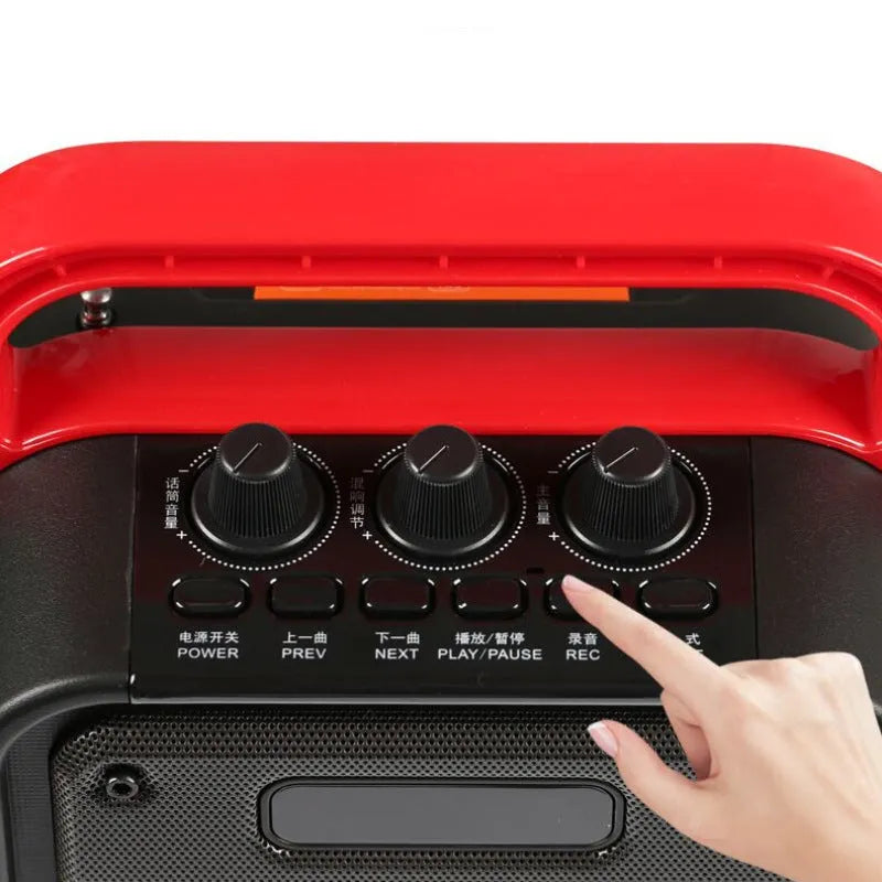 MS62AI portable Bluetooth speaker with wireless microphone on a table, showing control buttons and volume knob.