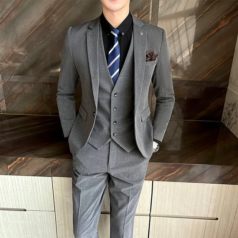 Slim fit men's business suit in black or dark grey with cotton blend fabric construction