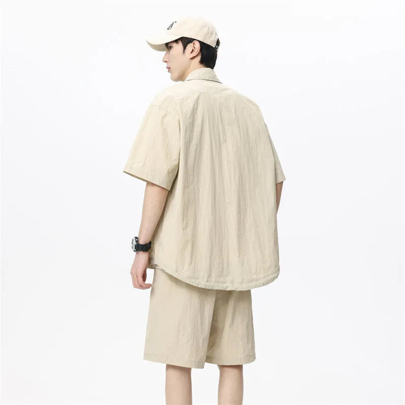 Man wearing a loose dark grey hemp-blend shirt and matching shorts casual two-piece set.
